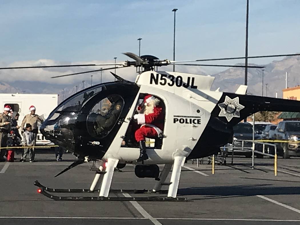 Santa Claus arrives in a Metropolitan Police Department helicopter during a "Santa Cops" event ...