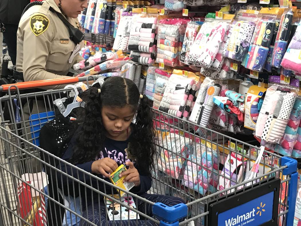 Cathalina Correa, 6, colors during a "Santa Cops" event on Saturday, Dec. 14, 2019, at Walmart ...