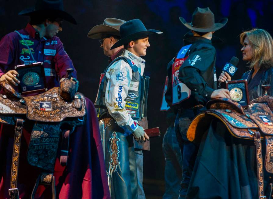 Stetson Wright of Milford, Utah, center, is named the All-Around World Champion following the t ...