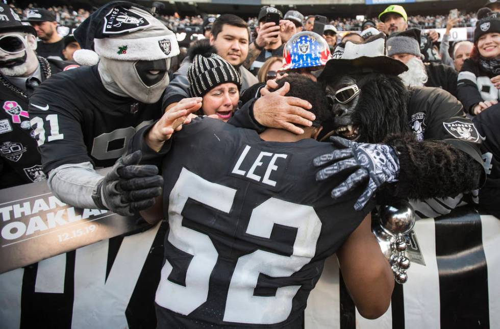 Oakland Raiders middle linebacker Marquel Lee (52) hugs fans in the "Black Hole" afte ...