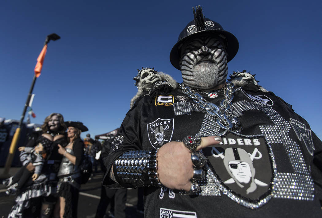 "The Hollywood Raider," right, at a tailgate outside the Oakland Coliseum before the ...