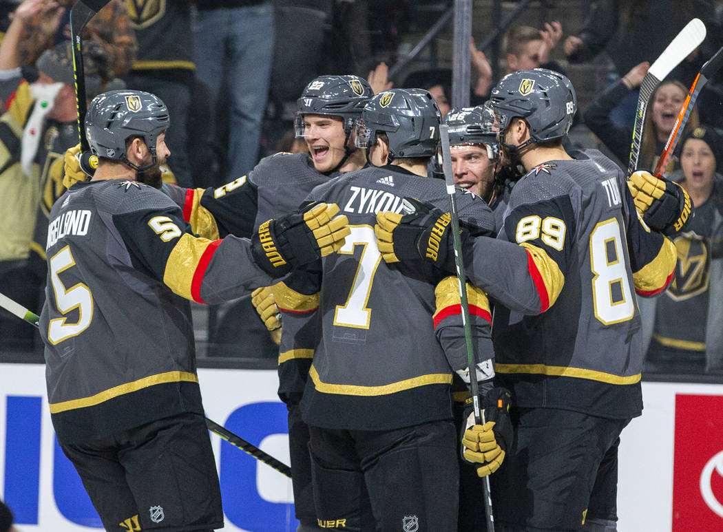 Vegas Golden Knights defenseman Nick Holden (22, center) celebrates a goal with teammates durin ...