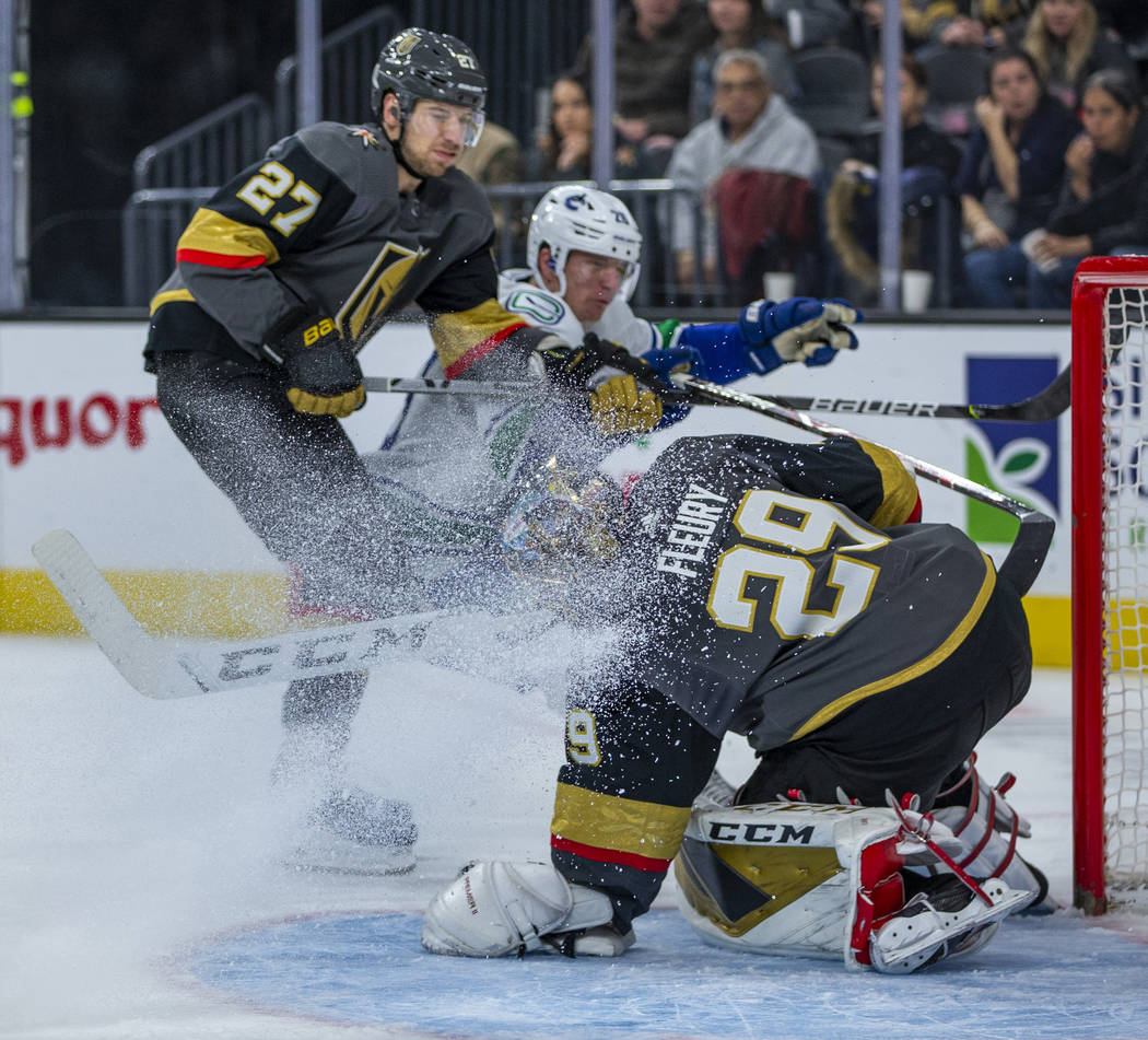 Vegas Golden Knights goaltender Marc-Andre Fleury (29) traps another shot on goal while getting ...