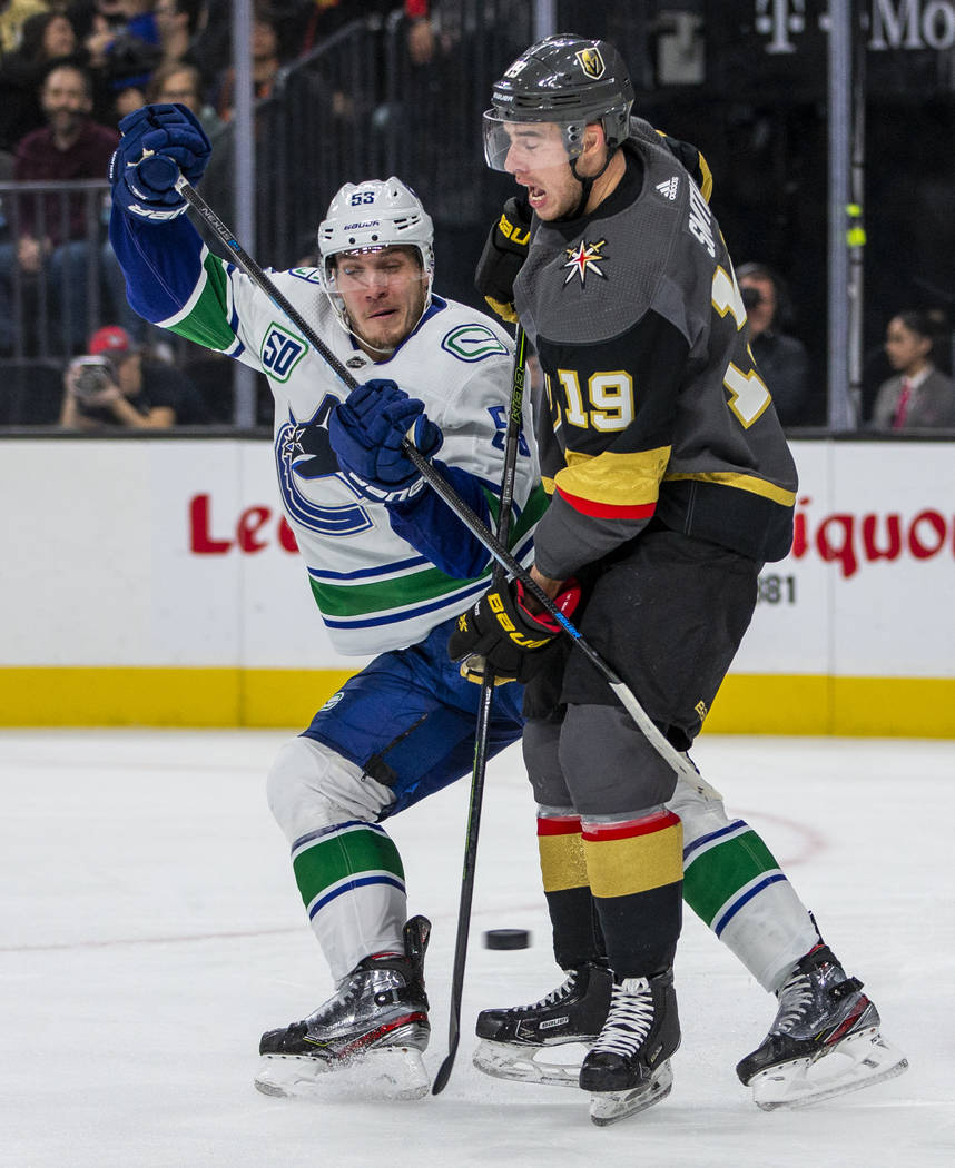 Vancouver Canucks center Bo Horvat (53, left) crashes into Vegas Golden Knights right wing Reil ...