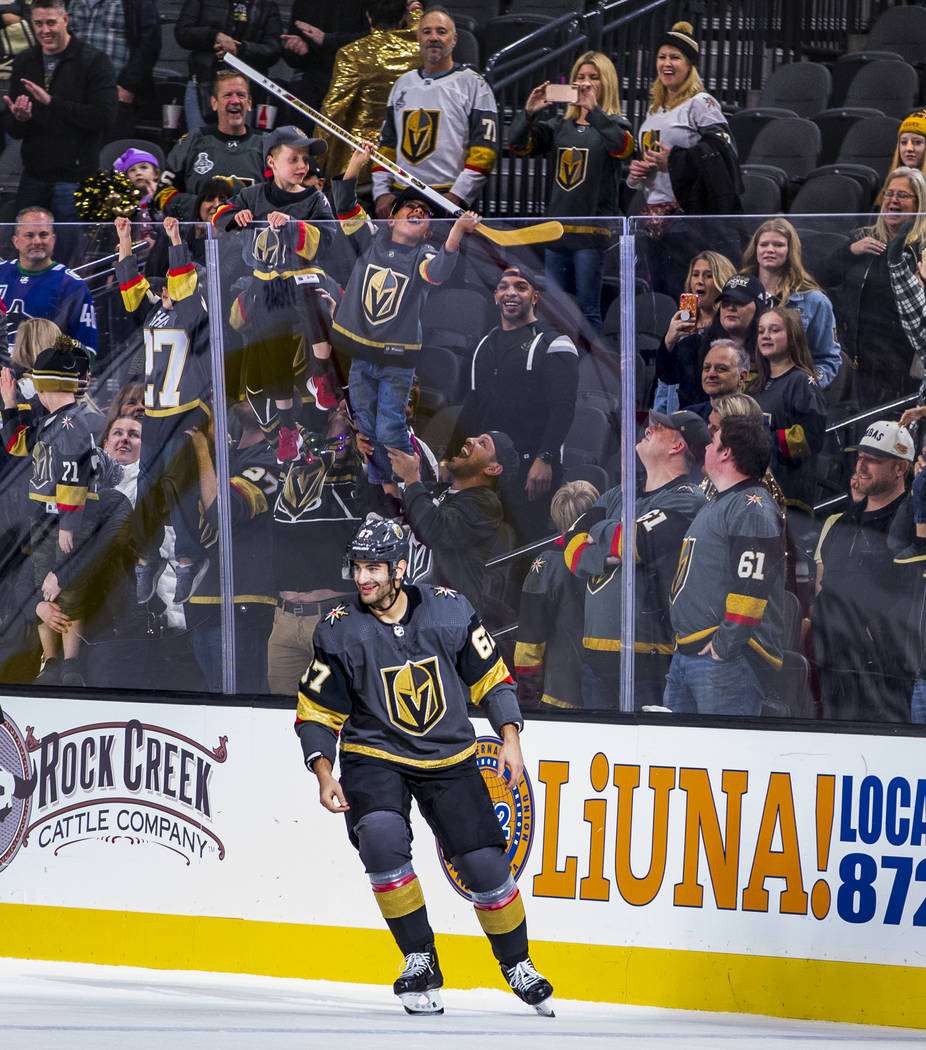 A lucky fan gets a stick from Vegas Golden Knights left wing Max Pacioretty (67) after 2 goals ...