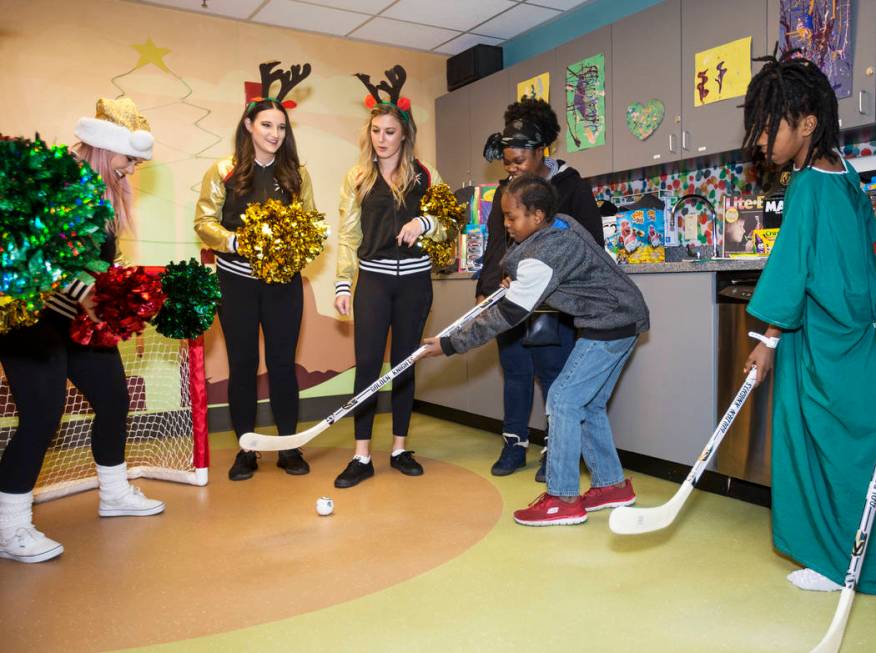 Vegas Vivas! cheerleader Samantha G., from left, guards the goal as Knights Guards members Roch ...