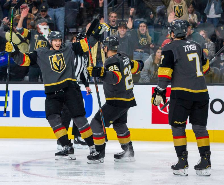 Vegas Golden Knights defenseman Nick Holden (22, left) celebrates a goal with Vegas Golden Knig ...