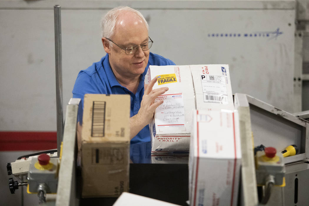 Chuck Thieman, who has worked at the USPS Mail Processing Annex for more than 30 years, sorts p ...