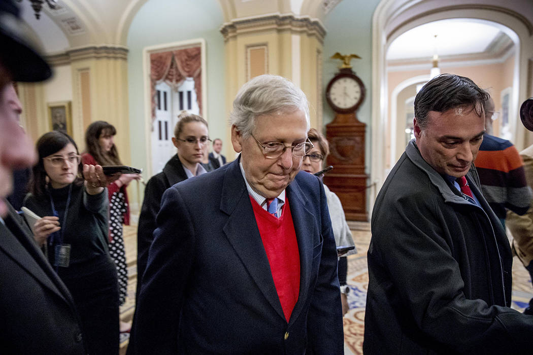 Senate Majority Leader Mitch McConnell of Ky., walks to the Senate Chamber, Monday, Dec. 16, 20 ...