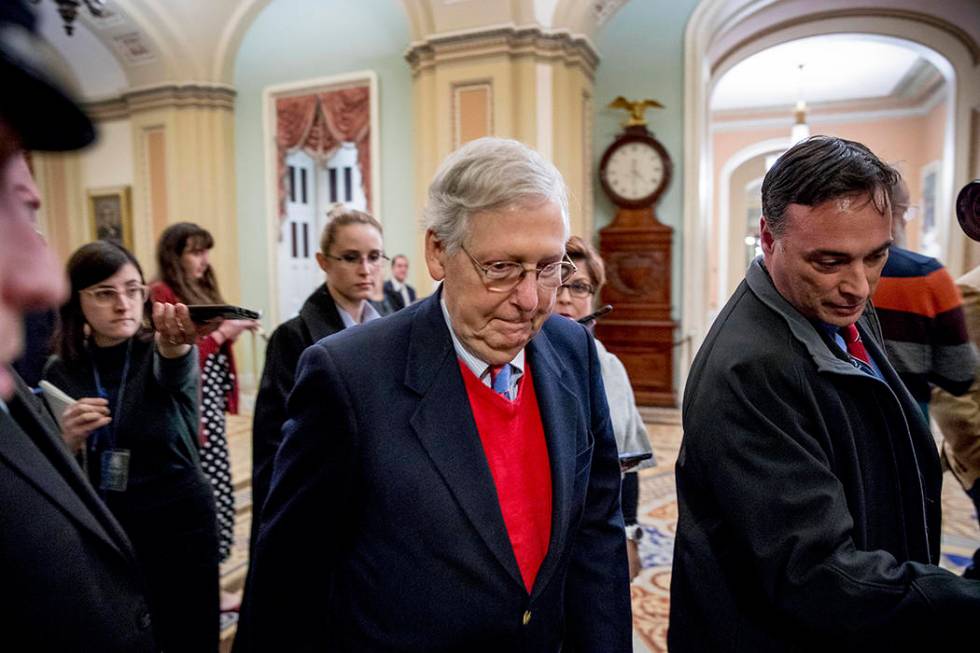 Senate Majority Leader Mitch McConnell of Ky., walks to the Senate Chamber, Monday, Dec. 16, 20 ...