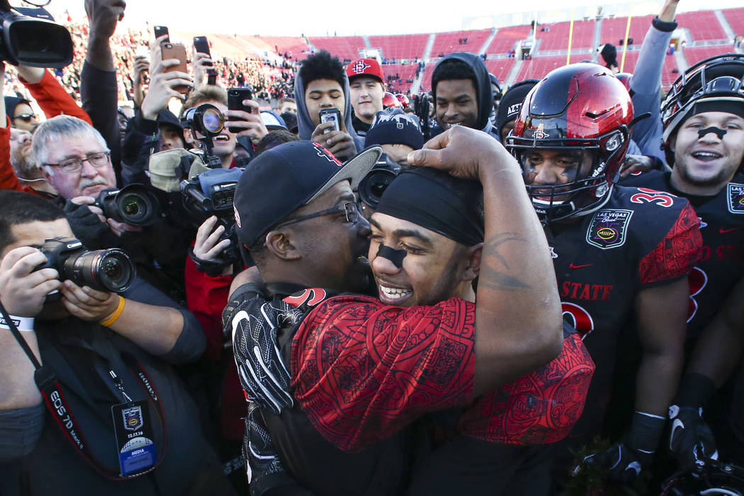 San Diego State running back Donnel Pumphrey (19) celebrates with his father, Donnel Humphrey S ...