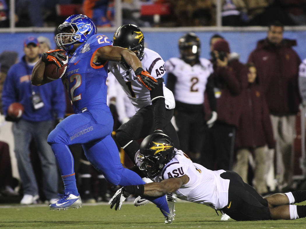 Boise State's Doug Martin (22) tries to outrun Arizona State's Keelan Johnson (10) during the M ...