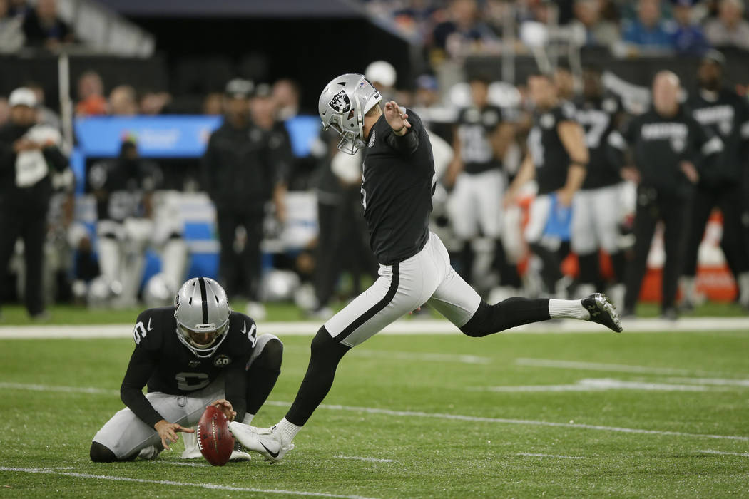 Oakland Raiders kicker Daniel Carlson (8) kicks a field goal out of the hold of punter A.J. Col ...