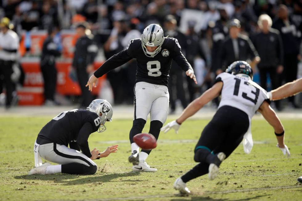 Oakland Raiders kicker Daniel Carlson (8) kicks a field goal as Jacksonville Jaguars wide recei ...