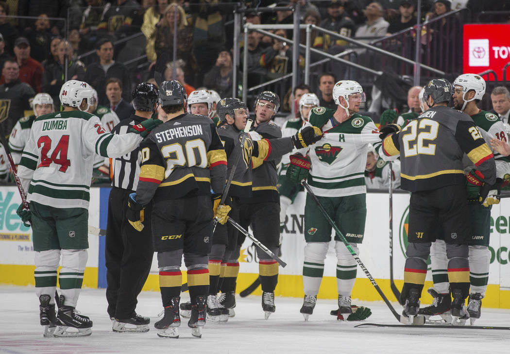 Minnesota Wild and Vegas Golden Knights players have to be separated in the second period of an ...