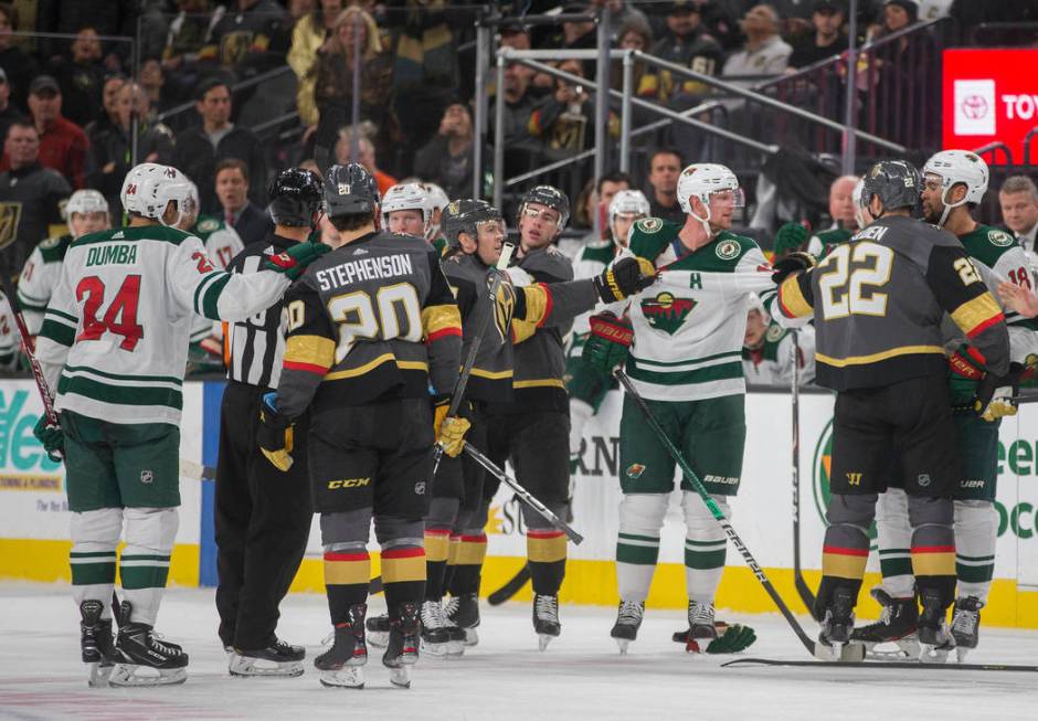 Minnesota Wild and Vegas Golden Knights players have to be separated in the second period of an ...