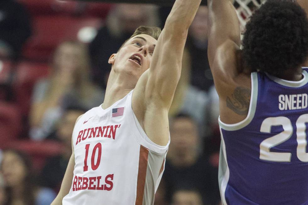 UNLV Rebels guard Jonah Antonio (10) reaches to block the shot of Kansas State Wildcats forward ...