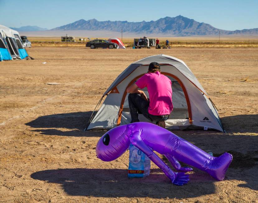 A festivalgoer starts to pack up his tent in the near-empty camping area during the Alienstock ...