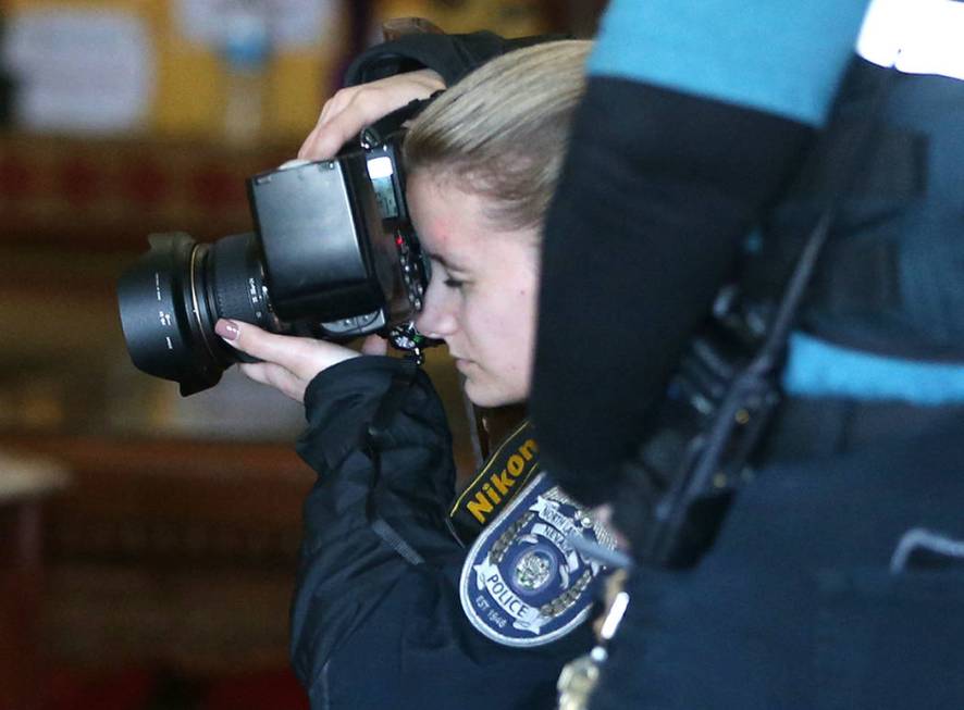 North Las Vegas Police Department crime scene investigators inspect inside the Thai Buddhist Te ...