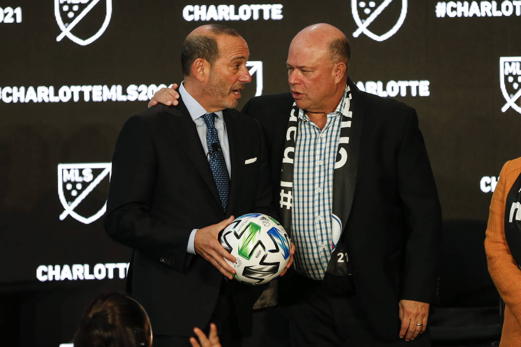 Major League Soccer Commissioner Don Garber, left, and Charlotte MLS owner David Tepper talk du ...