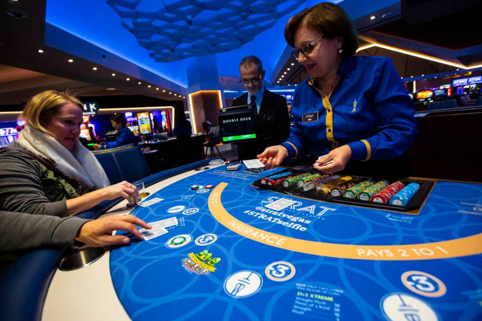 Blackjack dealer Amal Almisber works the table as John and Shannon Welt, of Grants Pass, Ore., ...