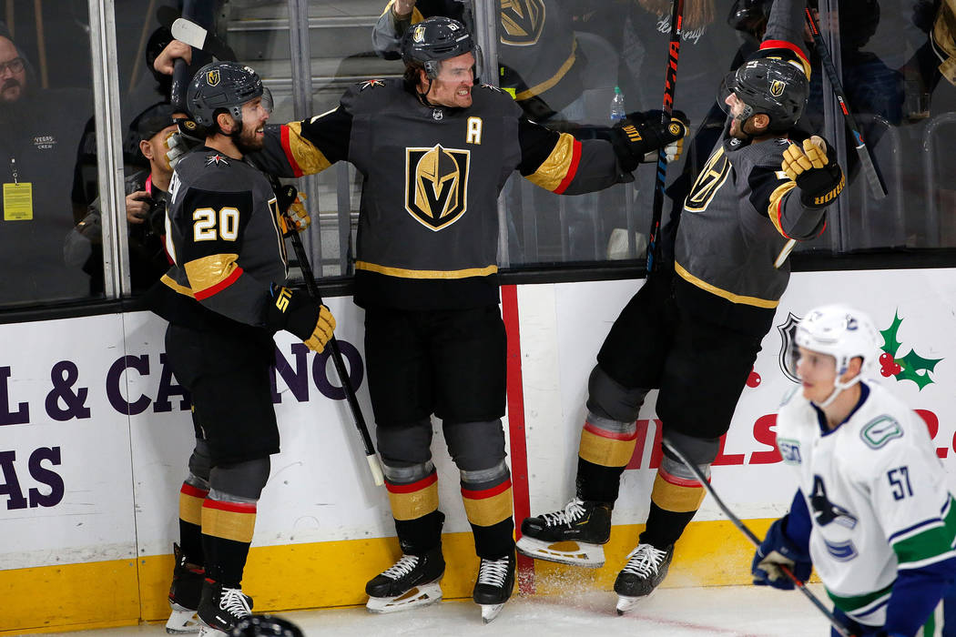 Vegas Golden Knights right wing Mark Stone (61) celebrates with his teammates center Chandler S ...