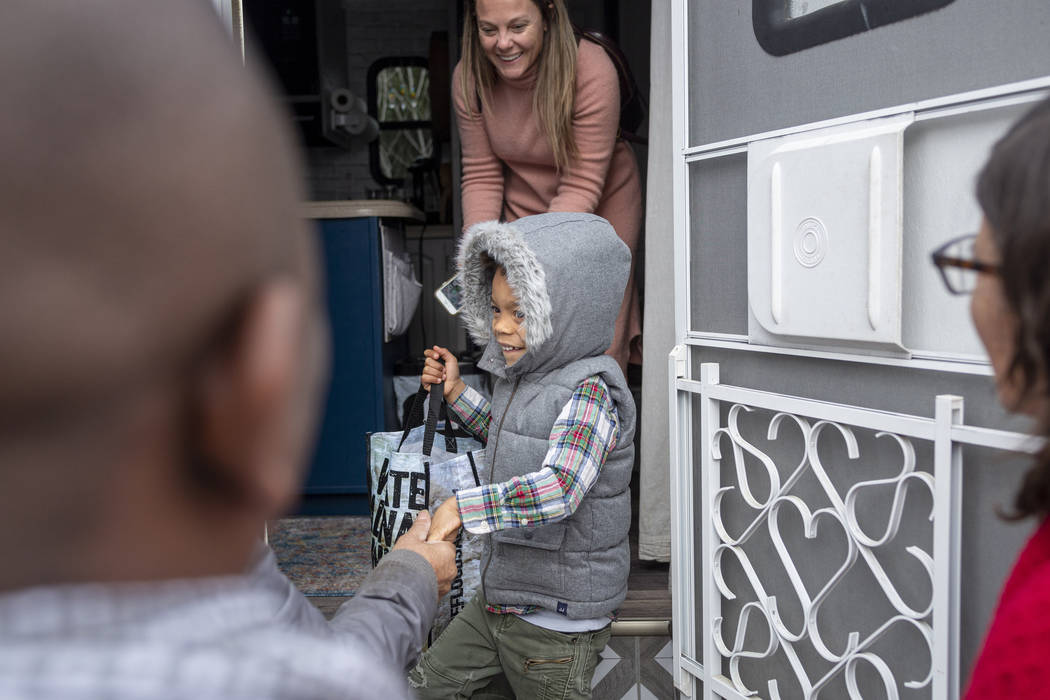 Jill Ajayi, back, and her son Olamide Ajayi, 6, center, surprises Olamide's mentor Lisa Bernaue ...