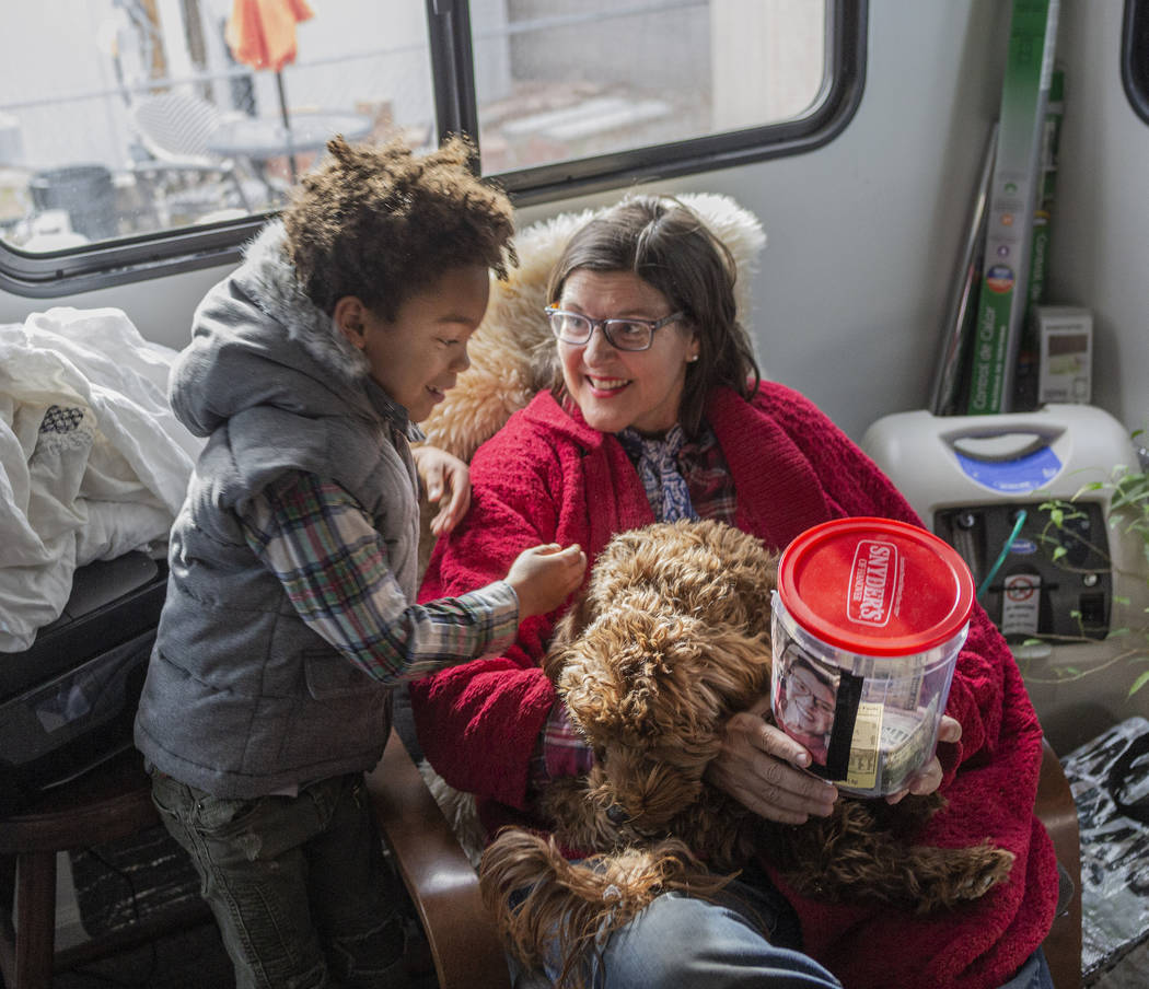 Olamide Ajayi, 6, surprises his mentor Lisa Bernauer with the $1,000 he raised for her cancer t ...