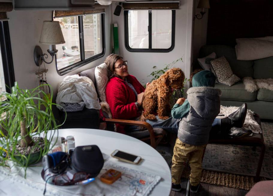 Ayotunde Ajayi, 4, listens as his education mentor Lisa Bernauer discuss her journey with her c ...