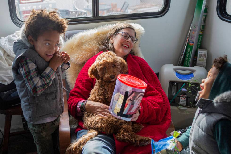 Olamide Ajayi, 6, left, his mentor Lisa Bernauer, center, and Ayotunde Ajayi, 4, give Bernauer ...