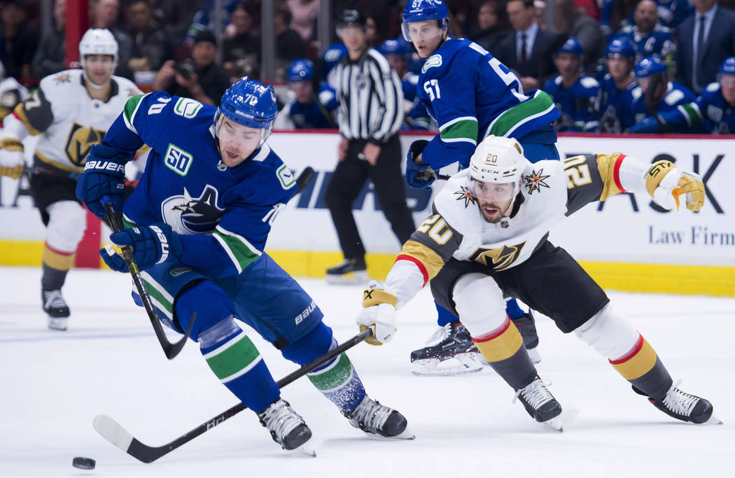 Vancouver Canucks left wing Tanner Pearson (70) vies for control of the puck with Vegas Golden ...