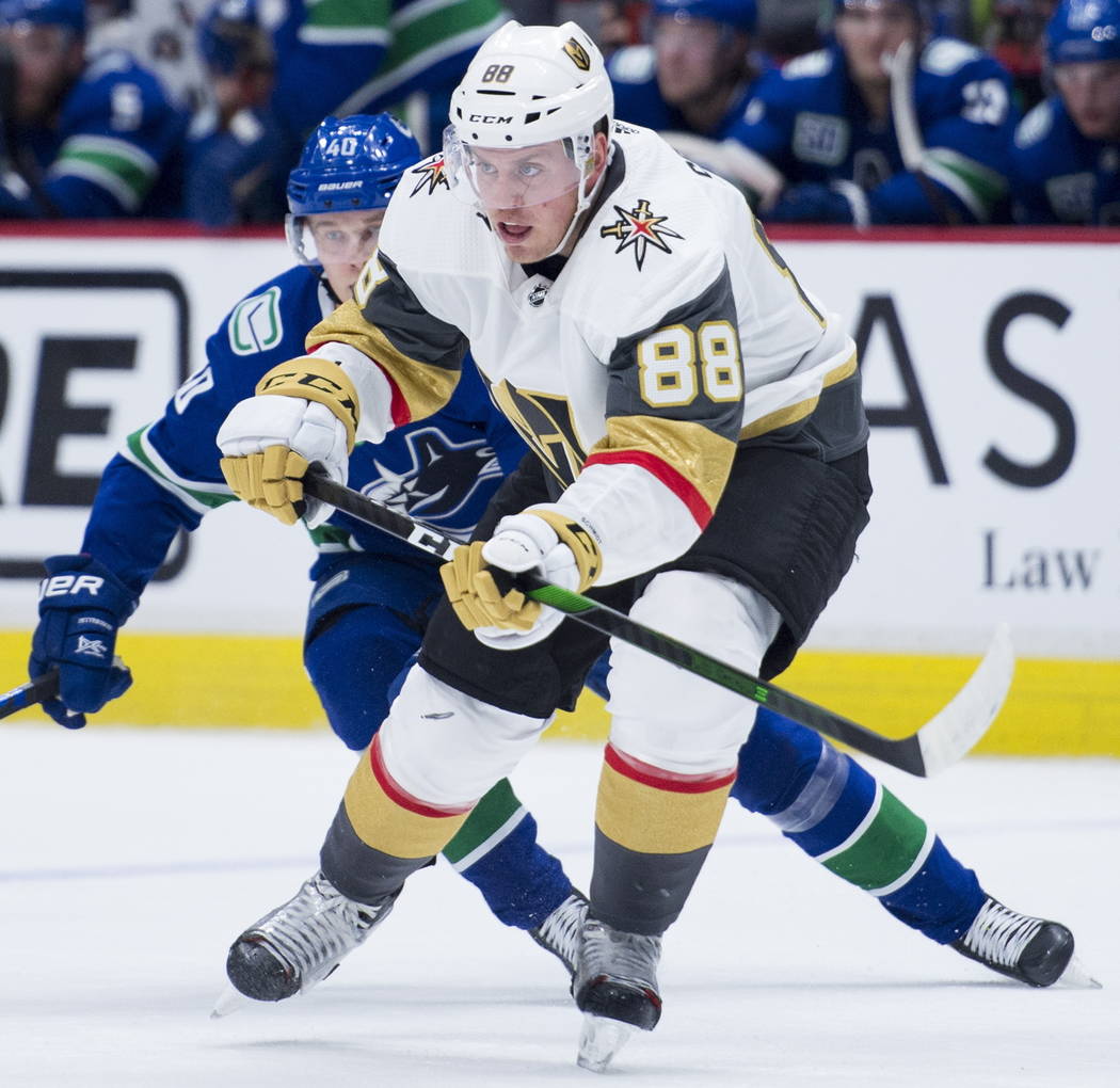 Vancouver Canucks center Elias Pettersson (40) chases Vegas Golden Knights defenseman Nate Schm ...