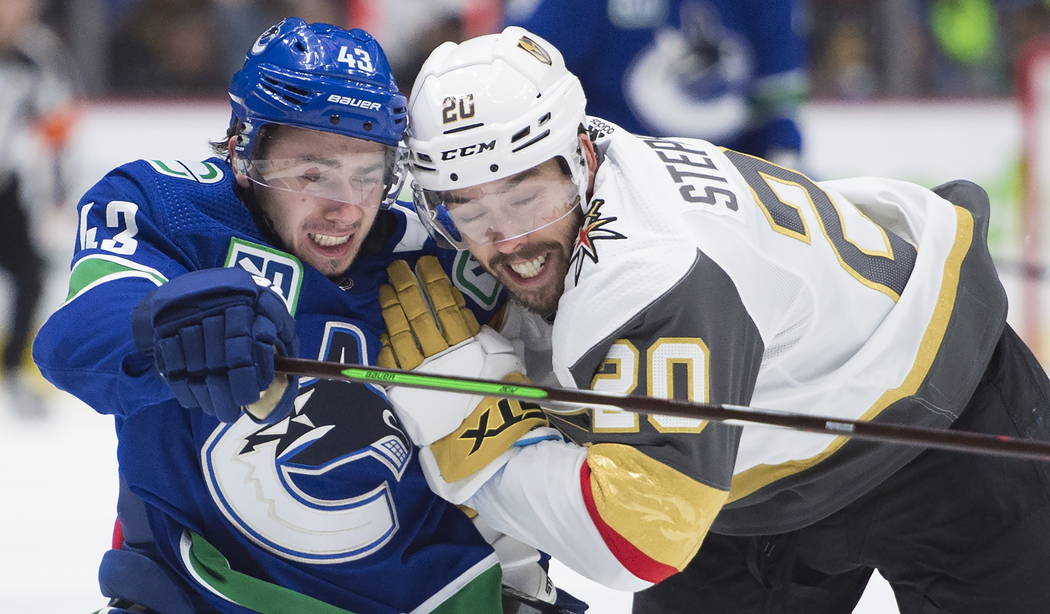 Vancouver Canucks defenseman Quinn Hughes (43) vies for control of the puck with Vegas Golden K ...