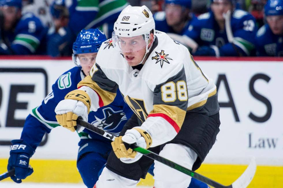 Vancouver Canucks center Elias Pettersson (40) chases Vegas Golden Knights defenseman Nate Schm ...