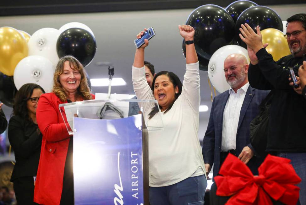 Hilda Black, of San Antonio, Texas, center, reacts after being designated as the 50 millionth p ...