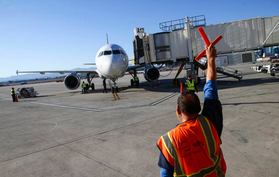 An Allegiant flight from San Antonio arrives at the gate after being welcomed with a water cann ...