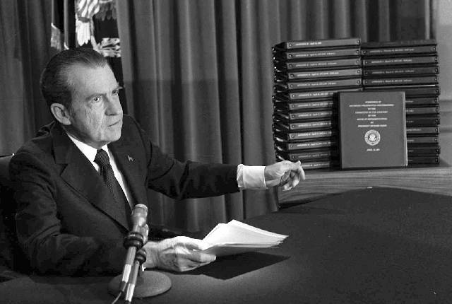 In this April 29, 1974, photo, President Richard M. Nixon points to the transcripts of the Whit ...