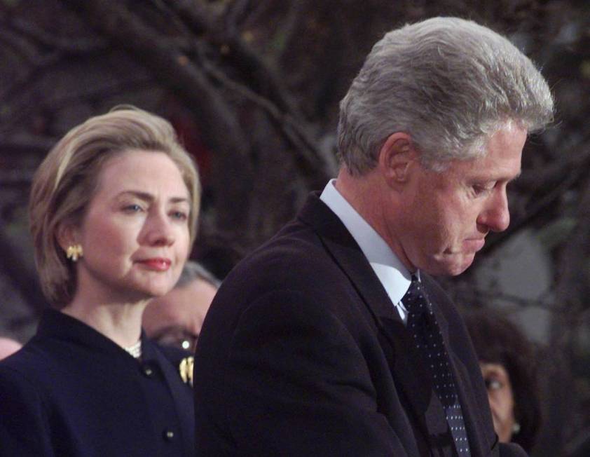 President Clinton makes a statement as first lady Hillary Rodham Clinton watches Dec. 19, 1998. ...