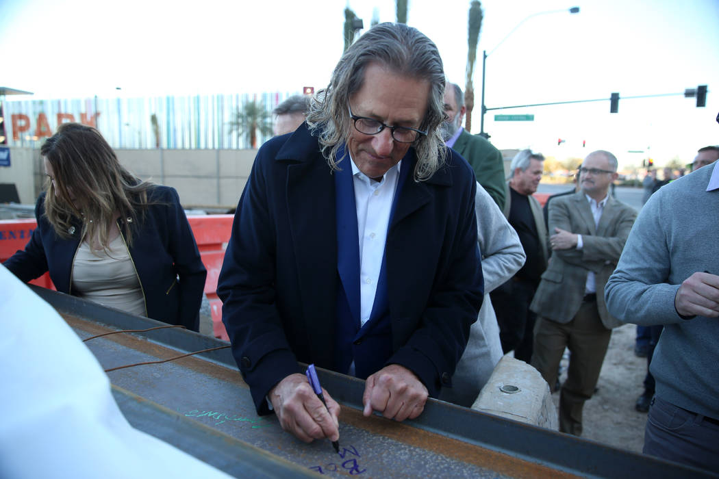 Bob Maricich, president and CEO of International Market Centers, signs a beam during a topping- ...
