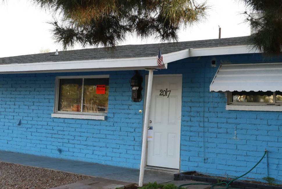 "Private Property" and "Unsafe to Occupy" signs are posted on the window of a house on South Sa ...