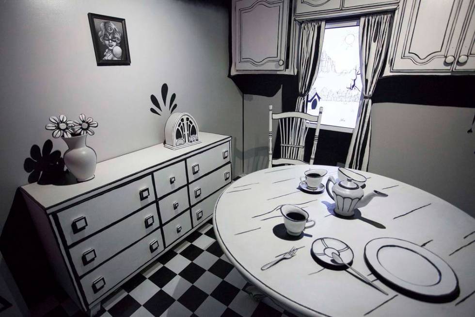 A monochromatic kitchen is filled with monsters at Meow Wolf House of Eternal Return.