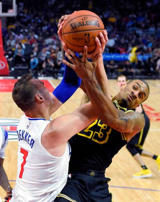 Los Angeles Clippers forward Sam Dekker, left, and Los Angeles Lakers guard Gary Payton II vie ...