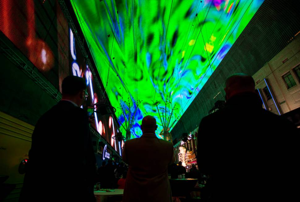 People watch the recently-upgraded Viva Vision screen during a preview of the new light show, & ...