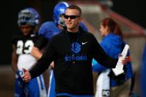 Boise State head coach Bryan Harsin, left, is seen during football practice in Las Vegas, Wedne ...