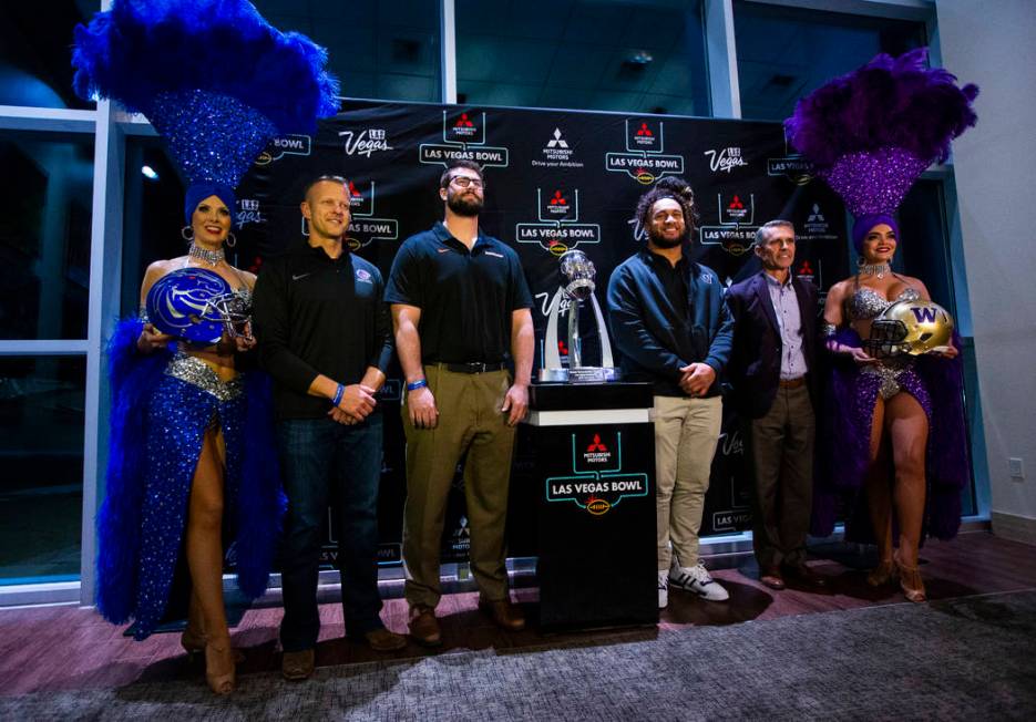 Showgirls Jennifer Autry, left, representing Boise State, and Porsha Revesz, far right, represe ...