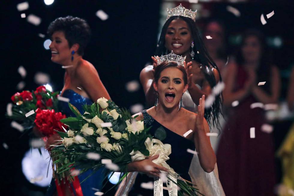 Camille Schrier, of Virginia, right, reacts after winning the Miss America competition at the M ...