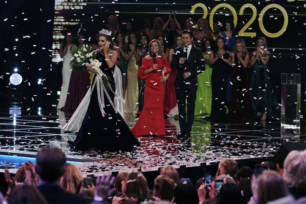 Camille Schrier, of Virginia, left, reacts after winning the Miss America competition at the Mo ...