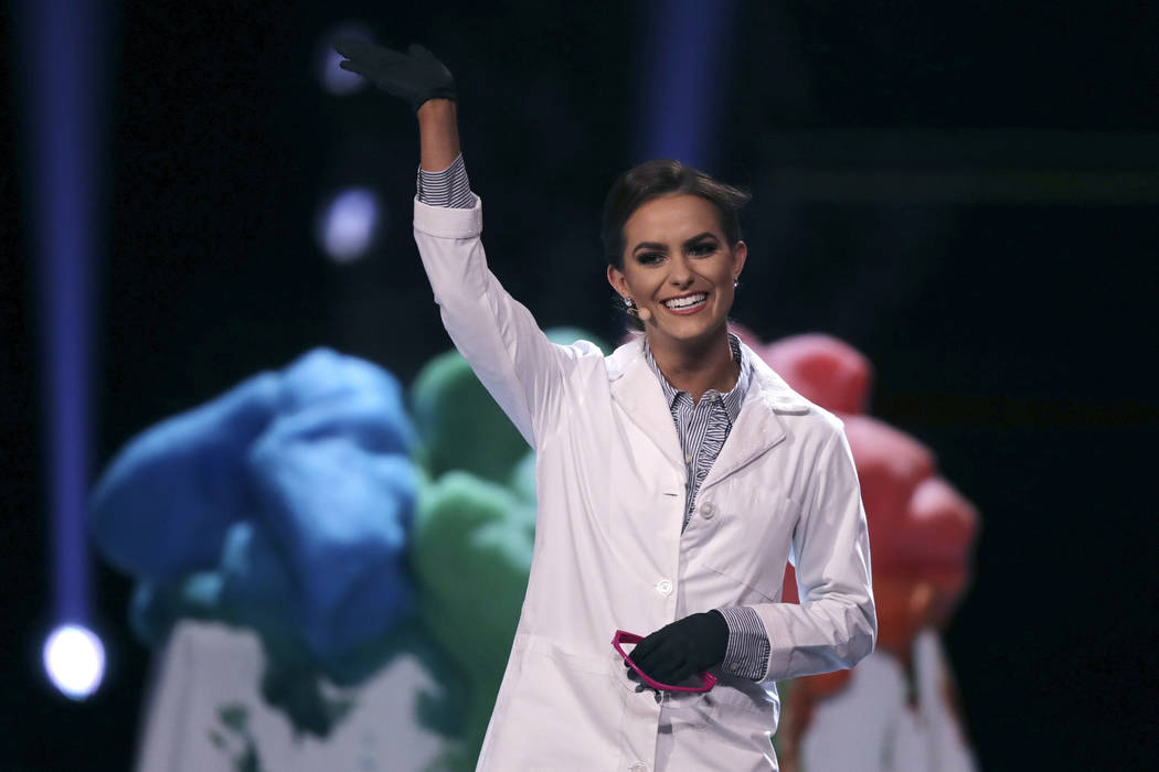 Camille Schrier, of Virginia, waves after performing a science experiment prior to winning the ...