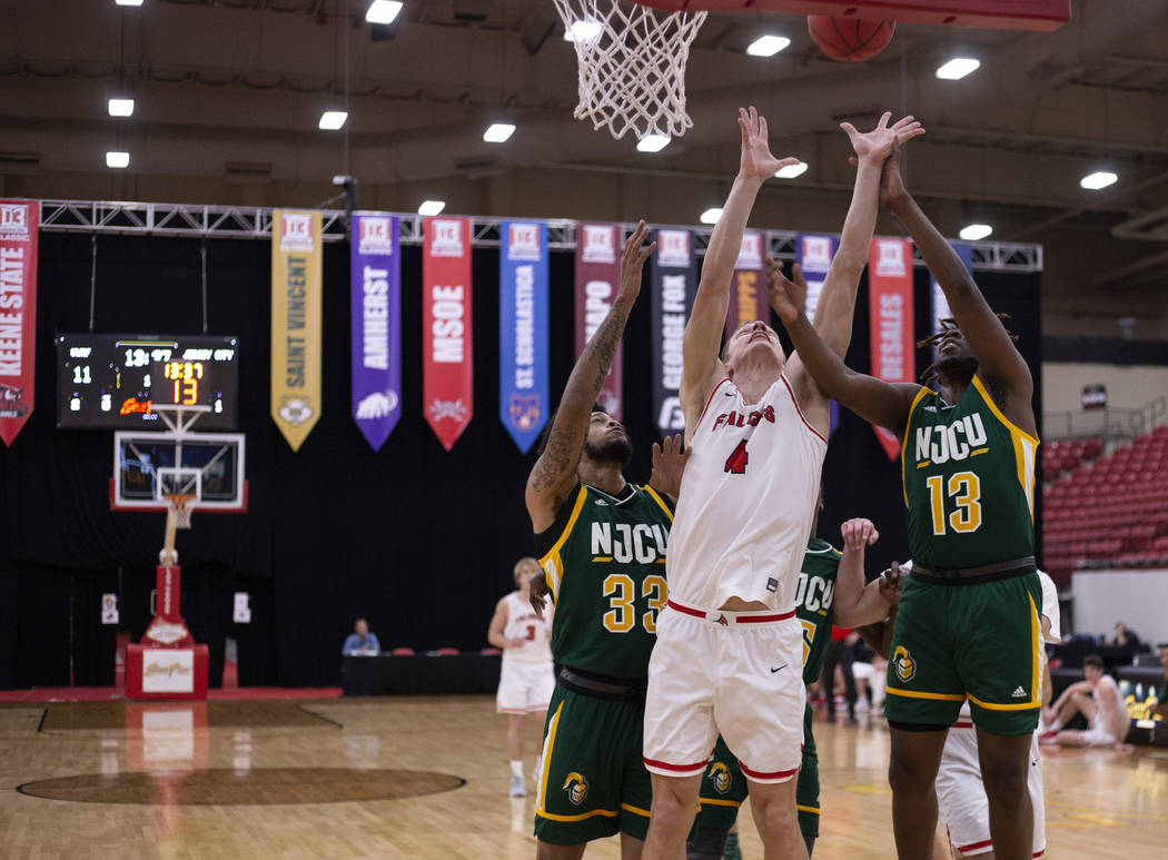 University of Wisconsin-River Falls' forward Alex Ohde (4) shoots a point as New Jersey City Un ...