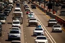 A police vehicle travels behind another car in the HOV lane northbound on Interstate 15 about T ...